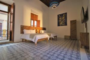 Postel nebo postele na pokoji v ubytování NaNa Vida Hotel Morelia