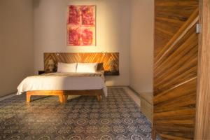 Postel nebo postele na pokoji v ubytování NaNa Vida Hotel Morelia