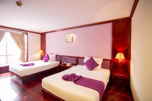 Postel nebo postele na pokoji v ubytování TTC Hotel - Da Lat