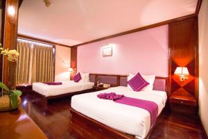 Postel nebo postele na pokoji v ubytování TTC Hotel - Da Lat