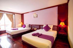 Postel nebo postele na pokoji v ubytování TTC Hotel - Da Lat