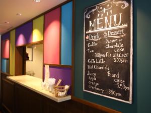 a menu board on the wall of a restaurant at KOKO HOTEL Ikebukuro in Tokyo