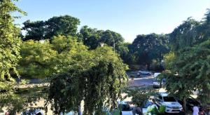 a parking lot with cars parked in a parking lot with trees at Atlas hotel in Islamabad