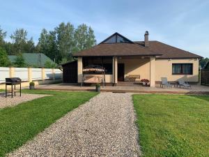 a house with a porch and a yard at Florin in Daugavpils