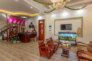 a living room with a tv and a fish tank at Anh Trang Homestay in Da Lat