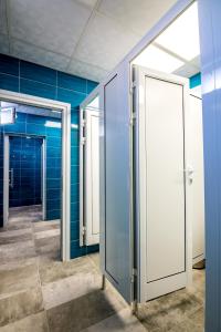 a row of glass doors in a room with blue walls at Hostel Kyosheto in Kŭrdzhali