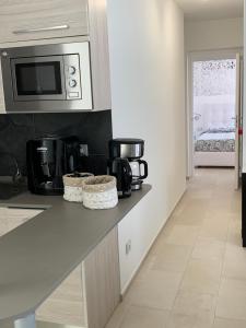 a kitchen with a counter top with a microwave at B&B Somiar in San Teodoro