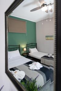 a mirror reflection of two beds in a room at Villa Gerasimoula in Lefkada