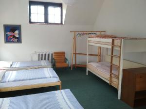 a room with three bunk beds and a window at Penzion U Tkadlen in Jindřichŭv Hradec