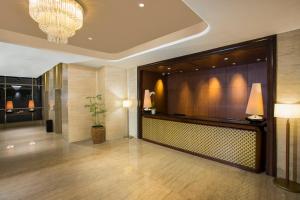 a lobby of a hotel with a potted plant at Swiss-Belhotel Bogor in Bogor