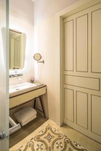 a bathroom with a sink and a door at The Norman Tel Aviv in Tel Aviv