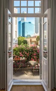 an open window with a view of a garden at The Norman Tel Aviv in Tel Aviv