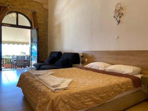 a bedroom with a large bed and a living room at Apanemia Rooms in Triopetra