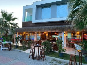 a restaurant with tables and chairs in front of a building at Zest Exclusive Hotel & Spa in Ortakent