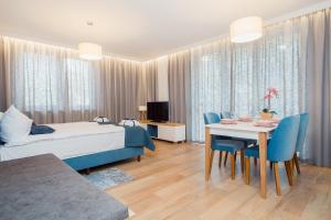 a bedroom with a bed and a table and chairs at ShortStayPoland Apartamenty in Warsaw