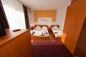a room with two beds and a desk and a room with two beds at Karol in Eforie Sud
