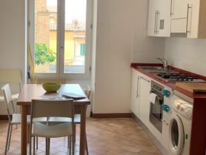 een keuken met een tafel en een fornuis top oven bij GH Paradiso - Apartments in Siena