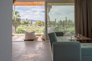 a living room with a couch and a view of the ocean at Laura maisons in Kalamata