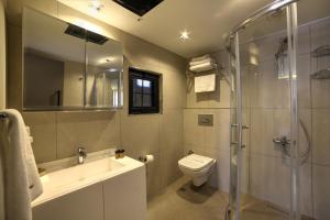 a bathroom with a toilet and a sink and a shower at The Capital Hotel in Istanbul