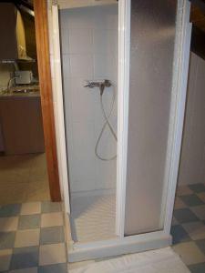 a shower with a glass door in a bathroom at Posada el Tocinero in Camargo