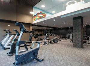 a gym with treadmills and cardio equipment in a building at Bodnar Apartamenty Nadmorskie Tarasy Port in Kołobrzeg