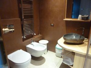 a bathroom with a sink and a toilet and a sink at Albergo Chalet Lago Antorno in Misurina