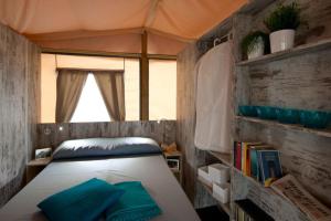 a bedroom with a bed in a tent at Camping Laguna Village in Caorle