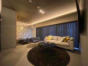 a living room with a couch and a table at Randor Residential Hotel Fukuoka Classic in Fukuoka