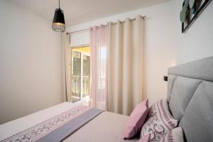 a bedroom with a white bedspread and pillows at Villa Vista in Jelsa