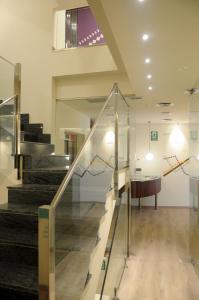 a lobby with stairs and a table in a building at APARTAMENTOS TURÍSTICOS GUIANA in Ponferrada