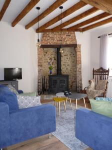 a living room with a blue couch and a fireplace at Een prachtige Gîte in Frankrijk Chez Gerard in Vieilleville