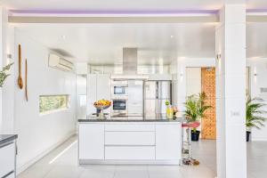 a kitchen with white cabinets and a counter top at Villa Jaliza - Chaweng Noi in Chaweng Noi Beach