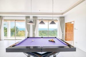 a purple pool table in a room with windows at Villa Jaliza - Luxury 7 bedroom Villa, Chaweng, Samui in Chaweng Noi Beach +68 photos