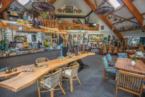 a restaurant with a large wooden table and chairs at Glamping tent Romala in Kiel