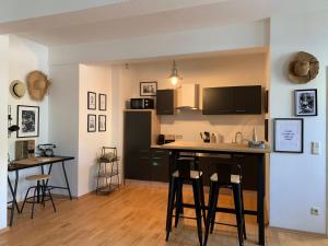 a kitchen with a bar and stools in a room at Sandra's Loft in Klagenfurt