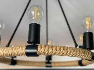 a chandelier with two light bulbs and a rope at Northern Hideaways Seahouses in Seahouses