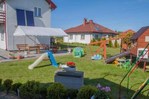 a backyard with a playground with a play equipment at Ranczo u Ani in Ustka