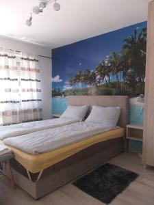 a bedroom with a bed with a painting on the wall at Apartman Mango Banja Luka center hospital Free parking in Banja Luka