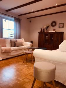 a living room with two white couches and a table at Ferienwohnung Jette mit Wallbox in Hanstedt