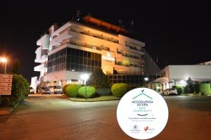 拉奎拉Canadian Hotel的晚上，建筑物前有招牌