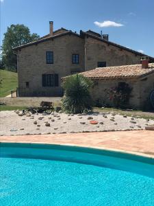 a house and a pool in front of a house at Domaine du Colombier, Gite La Liberte in Larroque