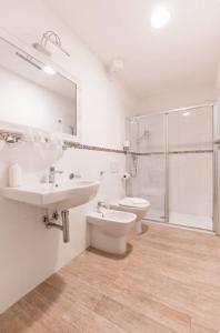 a bathroom with a sink and a toilet and a shower at Affittacamere Casa Dane' in La Spezia