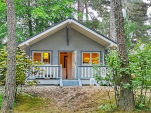 a small cottage in the woods with trees at Mistral przy plaży Domki całoroczne in Ustka