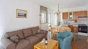 a living room with a couch and a table at Apartments Kalina in Jelsa
