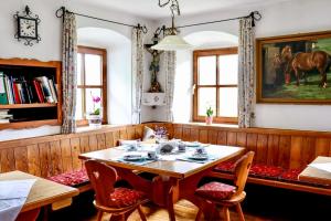 a dining room with a wooden table and chairs at Pension Schachernhof in Mittersill