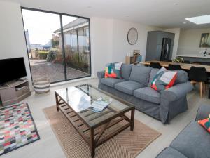 a living room with a couch and a table at Rosemary Cottage in Chathill