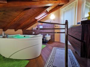 a large bathroom with a tub and a sink at Alba sul lago B&B in Stresa