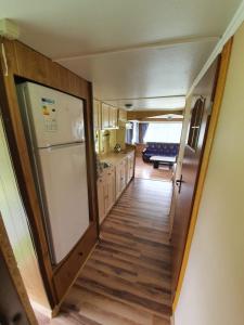 a hallway leading to a kitchen with a refrigerator at U Jędrusia in Polańczyk +73 photos