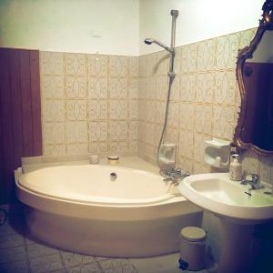 a bath tub and a sink in a bathroom at La Gallina Nel Castello in Albenga +106 photos