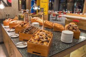 a bakery counter with many different types of pastries at ibis Alger Aéroport in Alger